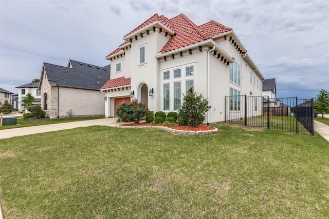 mediterranean / spanish-style home with concrete driveway, stucco siding, a garage, and a tiled roof