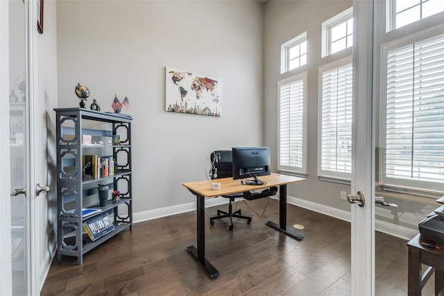 office space featuring french doors, dark wood-type flooring, and baseboards