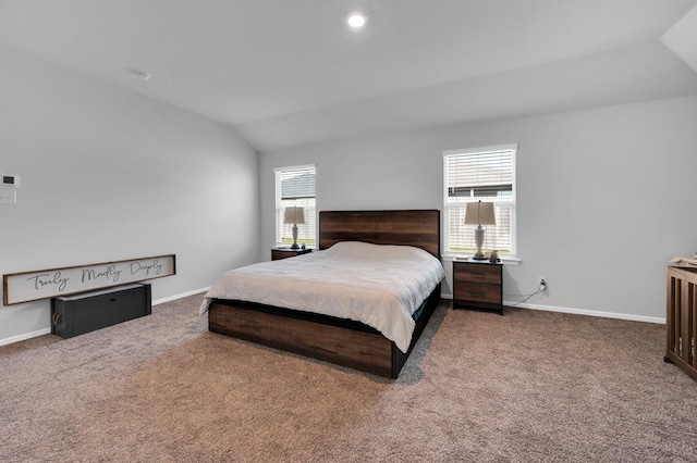 bedroom with lofted ceiling, carpet, and baseboards