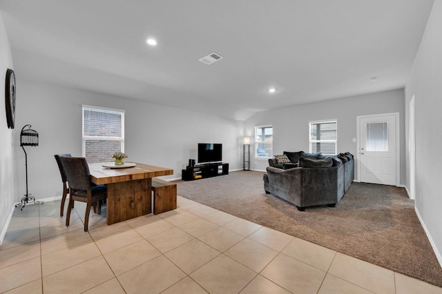 living room featuring light carpet, baseboards, recessed lighting, and light tile patterned floors
