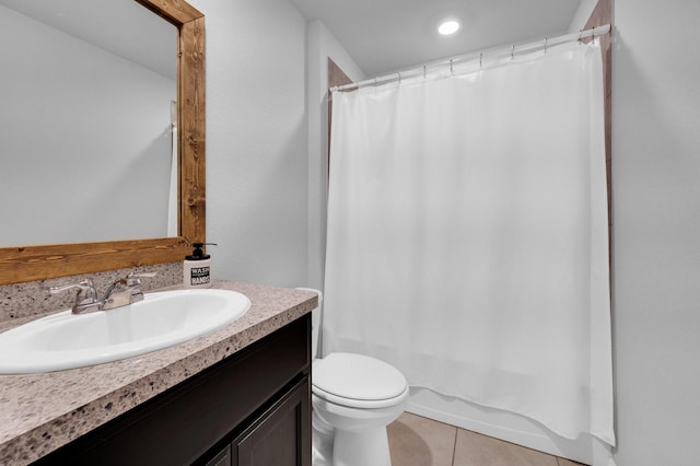 bathroom with toilet, tile patterned flooring, vanity, and shower / tub combo