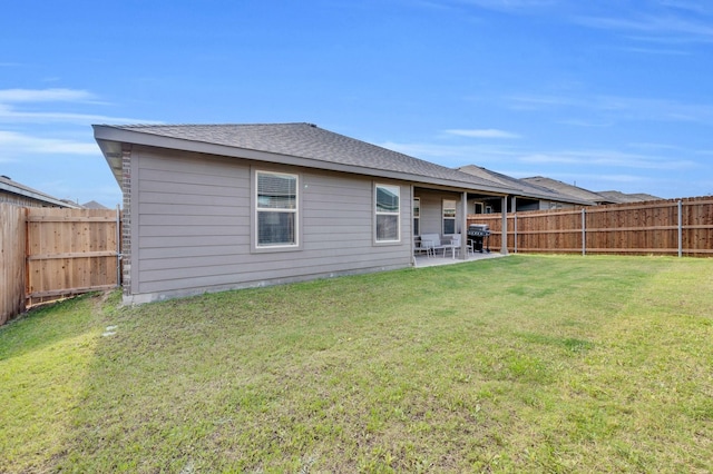 back of property featuring a patio and a shingled roof
