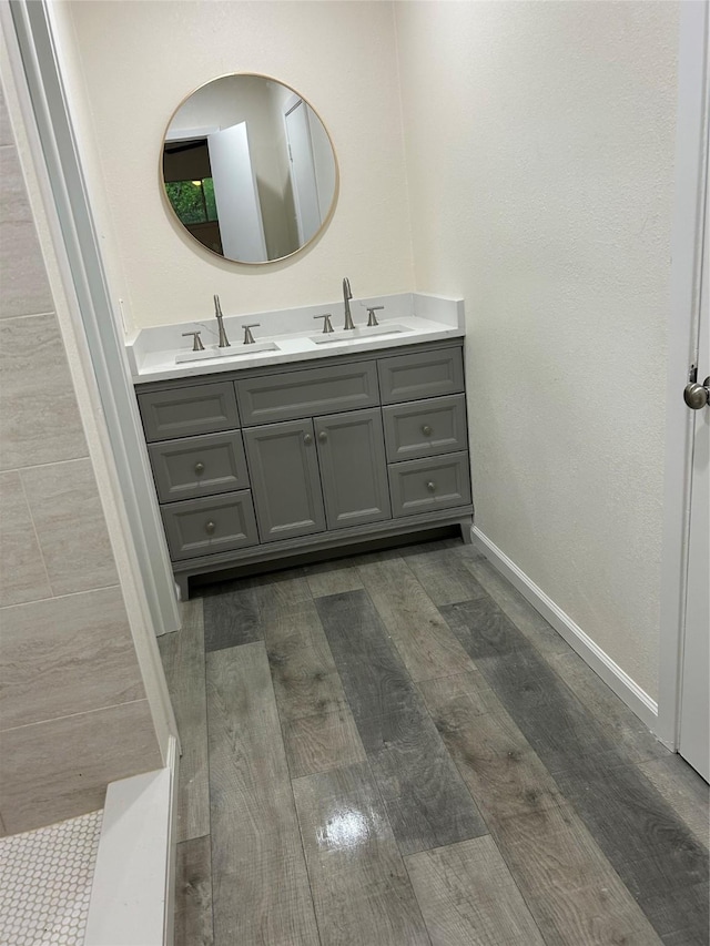 1109 Roman Rd, Grand Prairie, TX 75050 - bathroom with wood finished floors, double vanity, and baseboards