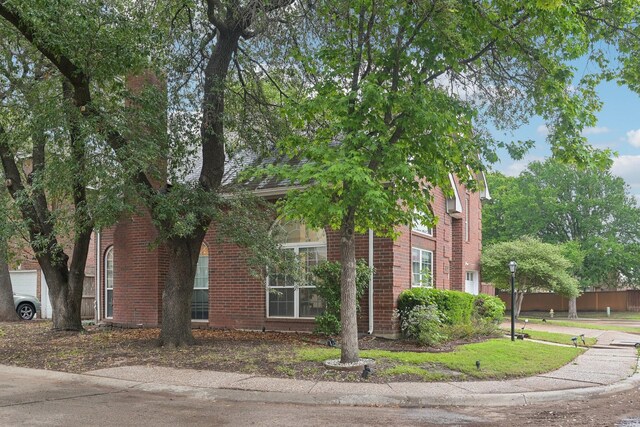 view of side of property with brick siding