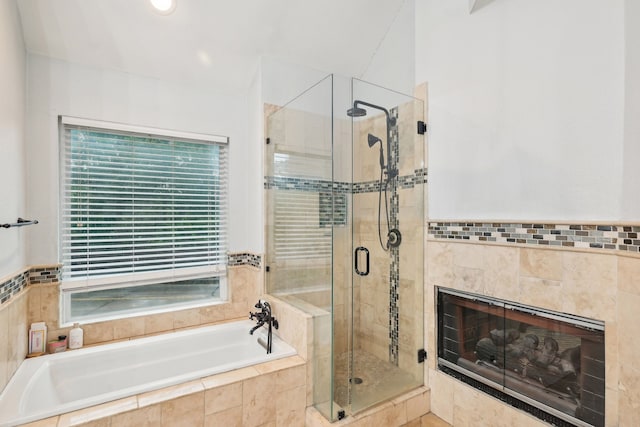 full bath featuring a shower stall, a garden tub, a tile fireplace, and recessed lighting
