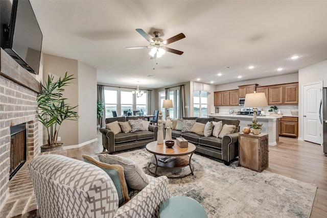 126 Range Ln, Decatur, TX 76234 - living area with a ceiling fan, light wood finished floors, a fireplace, baseboards, and a chandelier