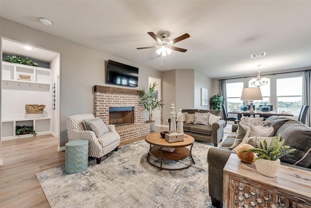 126 Range Ln, Decatur, TX 76234 - living area with wood finished floors, a ceiling fan, a fireplace, and baseboards