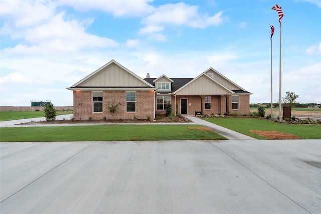 126 Range Ln, Decatur, TX 76234 - craftsman inspired home with brick siding, board and batten siding, and a front yard