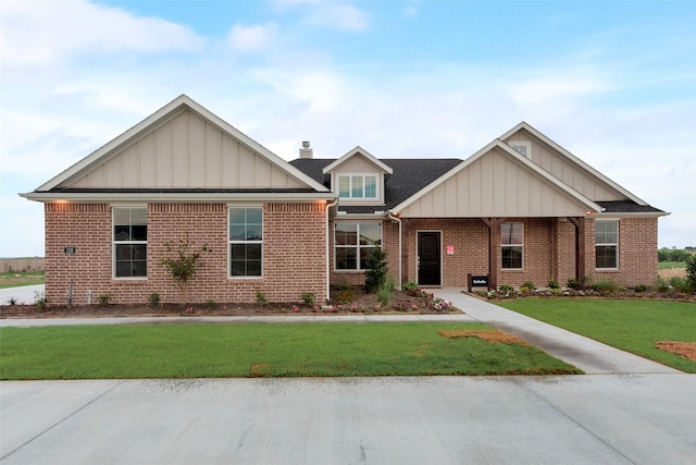 126 Range Ln, Decatur, TX 76234 - craftsman inspired home with board and batten siding, brick siding, a front yard, and a chimney