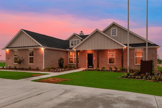 126 Range Ln, Decatur, TX 76234 - view of front facade with board and batten siding, brick siding, a lawn, and a chimney