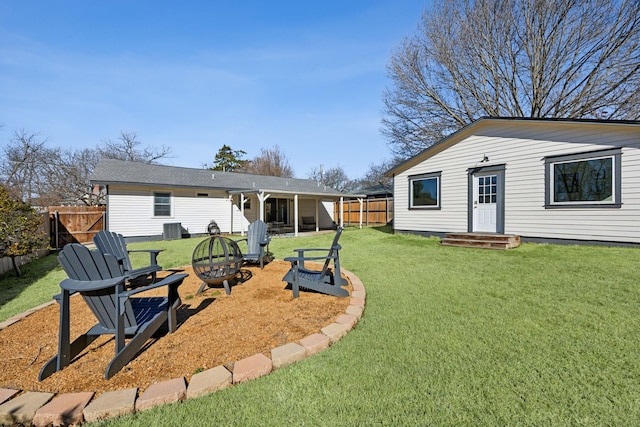 view of yard featuring a fire pit and central air condition unit