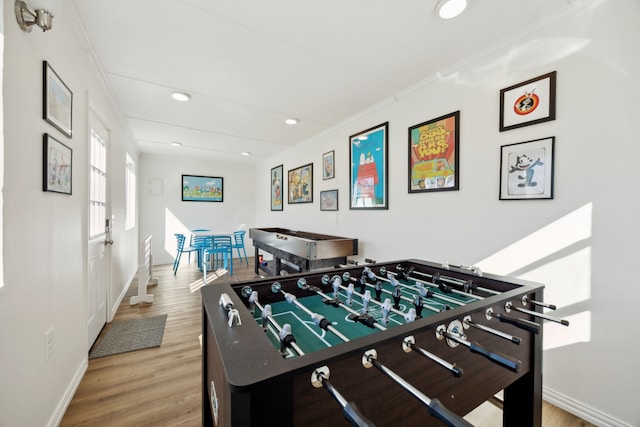 rec room with baseboards, ornamental molding, wood finished floors, and recessed lighting