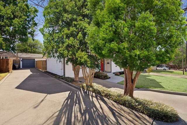 obstructed view of property featuring asphalt driveway