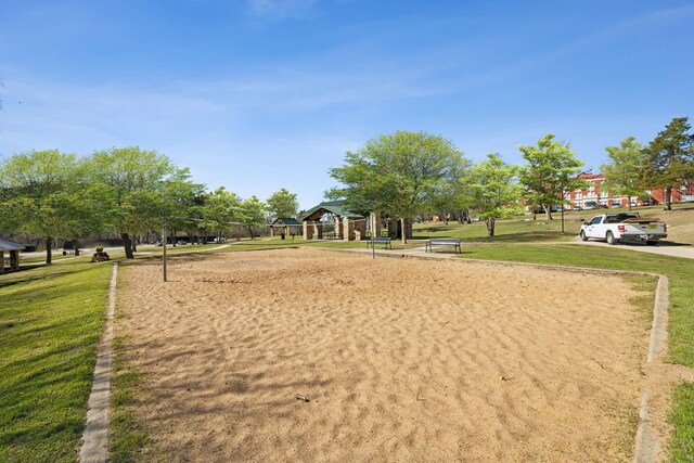 surrounding community with a gazebo, volleyball court, and a lawn