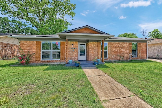 112 S Wood Ave, Denison, TX 75020 - ranch-style home with a front lawn and brick siding