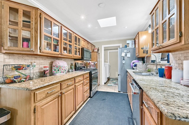 112 S Wood Ave, Denison, TX 75020 - kitchen featuring stainless steel appliances, a sink, a skylight, glass insert cabinets, and decorative backsplash