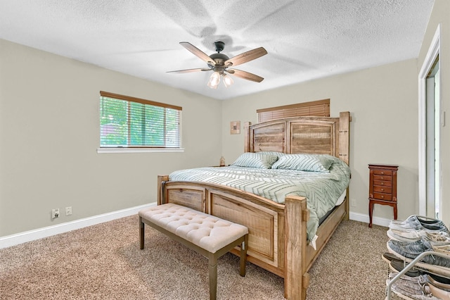 112 S Wood Ave, Denison, TX 75020 - bedroom featuring light colored carpet, baseboards, a ceiling fan, and a textured ceiling