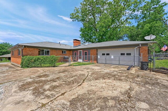 112 S Wood Ave, Denison, TX 75020 - ranch-style house with brick siding, driveway, and an attached garage
