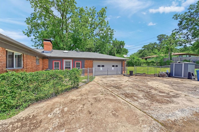 112 S Wood Ave, Denison, TX 75020 - view of side of home with brick siding, a chimney, fence, and a garage