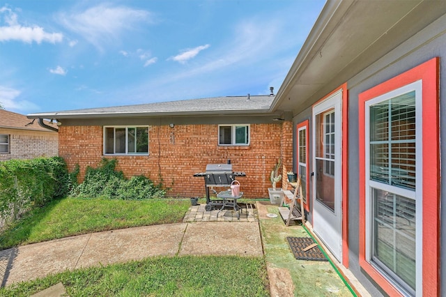 112 S Wood Ave, Denison, TX 75020 - back of property featuring a patio and brick siding