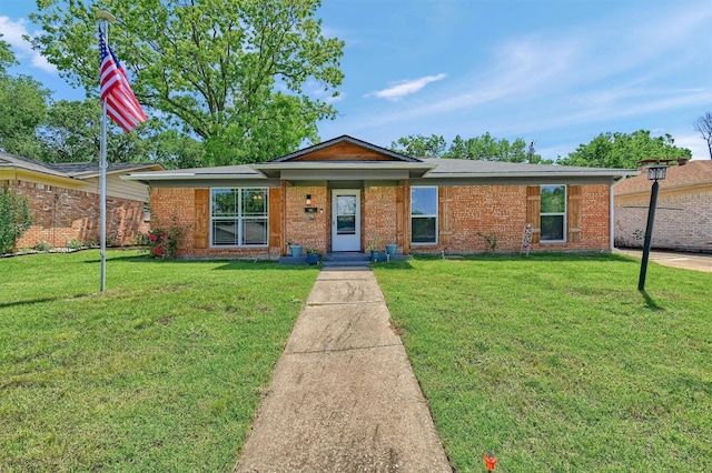 112 S Wood Ave, Denison, TX 75020 - ranch-style house featuring a front lawn and brick siding