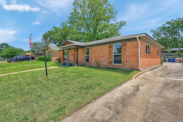 112 S Wood Ave, Denison, TX 75020 - ranch-style home featuring brick siding, a front lawn, and concrete driveway