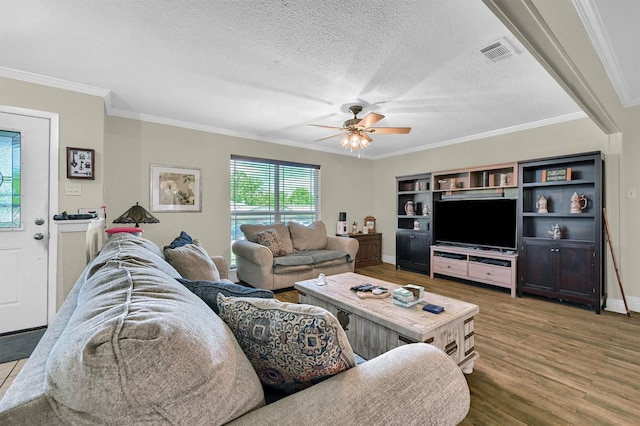 112 S Wood Ave, Denison, TX 75020 - living room with wood finished floors, ceiling fan, a textured ceiling, ornamental molding, and baseboards