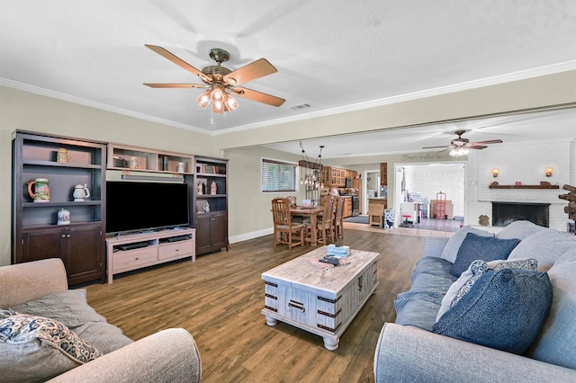 112 S Wood Ave, Denison, TX 75020 - living area with a ceiling fan, dark wood finished floors, crown molding, baseboards, and a brick fireplace