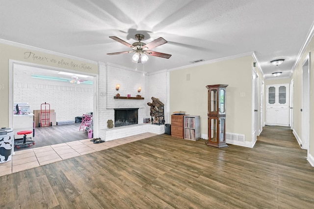 112 S Wood Ave, Denison, TX 75020 - living room featuring wood finished floors, ceiling fan, ornamental molding, a fireplace, and baseboards