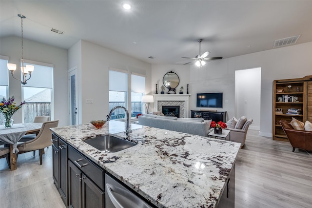 7412 Foxgrass Pl, Fort Worth, TX 76123 - kitchen with a sink, a tile fireplace, light wood finished floors, open floor plan, and recessed lighting