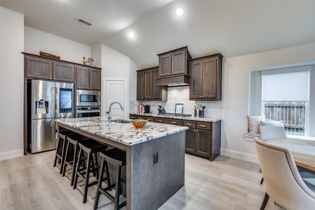 7412 Foxgrass Pl, Fort Worth, TX 76123 - kitchen with stainless steel appliances, a sink, baseboards, decorative backsplash, and dark brown cabinetry