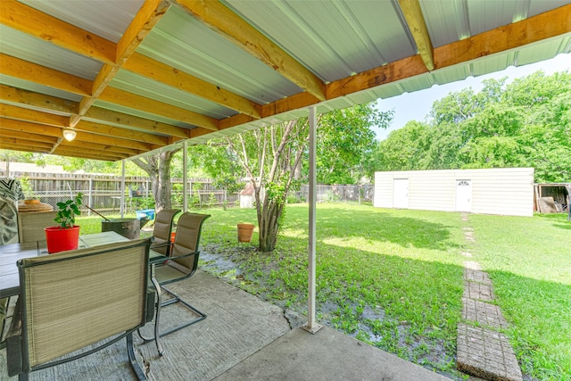 2957 Darby Dr, Dallas, TX 75227 - view of patio / terrace with a shed, outdoor dining space, and an outbuilding