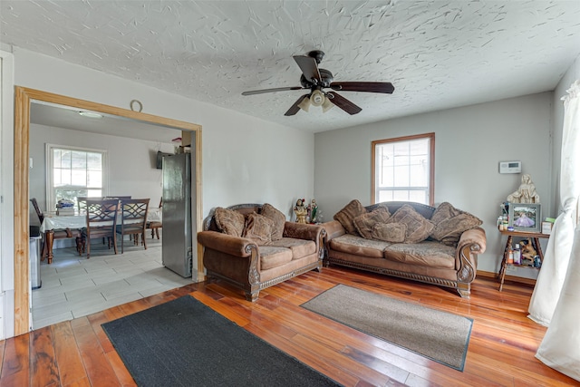 2957 Darby Dr, Dallas, TX 75227 - living area with a ceiling fan, light wood finished floors, and a textured ceiling