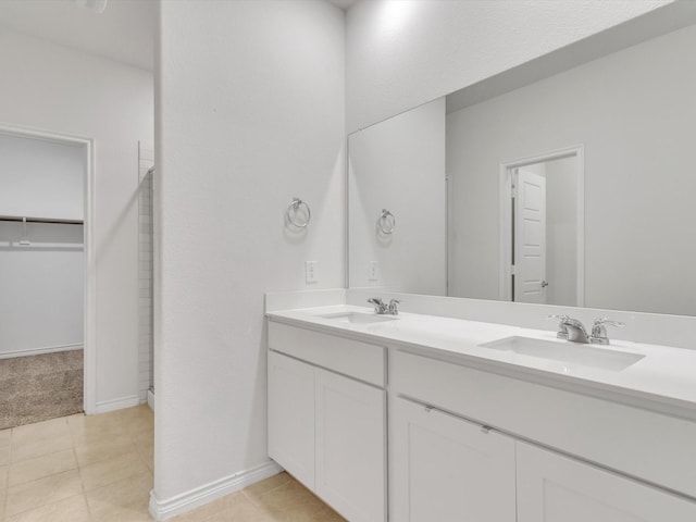 1116 Cobalt Dr, Celina, TX 75009 - bathroom with double vanity, tile patterned floors, baseboards, and a spacious closet