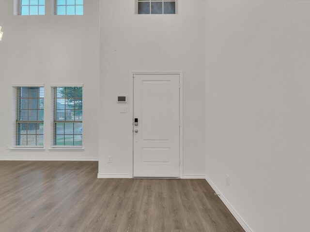 1116 Cobalt Dr, Celina, TX 75009 - foyer entrance with wood finished floors, baseboards, healthy amount of natural light, and a towering ceiling