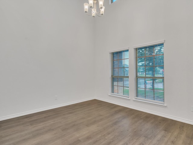 1116 Cobalt Dr, Celina, TX 75009 - empty room featuring a chandelier, dark wood-type flooring, baseboards, and a high ceiling