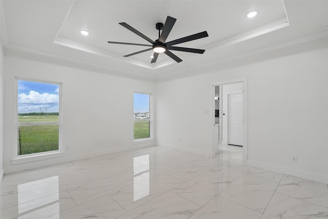 unfurnished room featuring a tray ceiling, baseboards, healthy amount of natural light, and recessed lighting