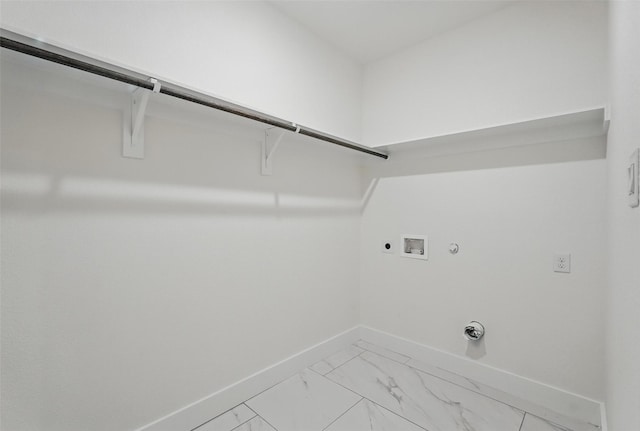 laundry area with hookup for a gas dryer, electric dryer hookup, washer hookup, light marble finish floors, and baseboards