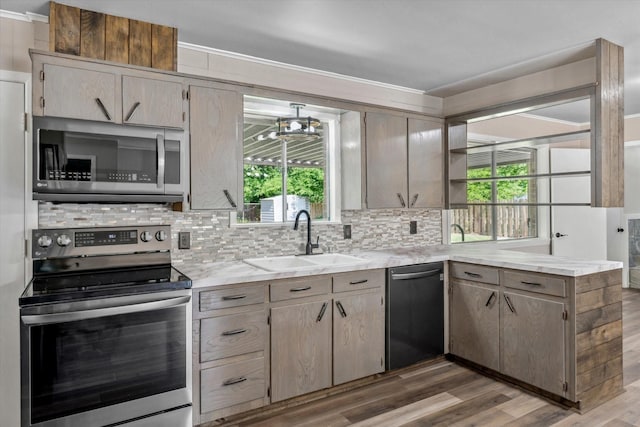 407 Sunset St, Malakoff, TX 75148 - kitchen with stainless steel appliances, a sink, backsplash, and plenty of natural light