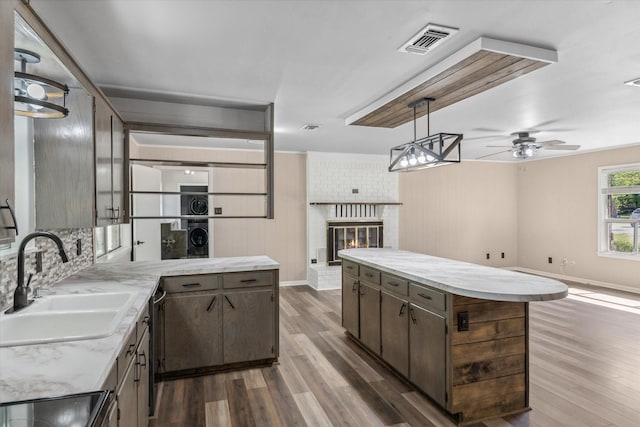 407 Sunset St, Malakoff, TX 75148 - kitchen with wood finished floors, a sink, open floor plan, and a fireplace