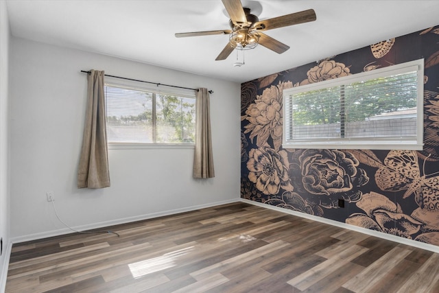 407 Sunset St, Malakoff, TX 75148 - empty room with healthy amount of natural light, wood finished floors, and a ceiling fan