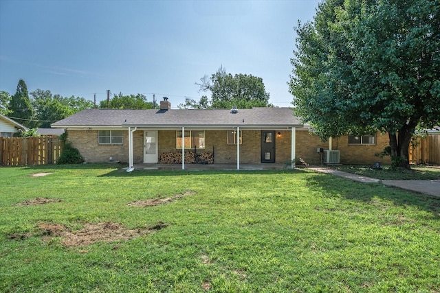407 Sunset St, Malakoff, TX 75148 - back of house featuring central AC, a patio, brick siding, and a chimney