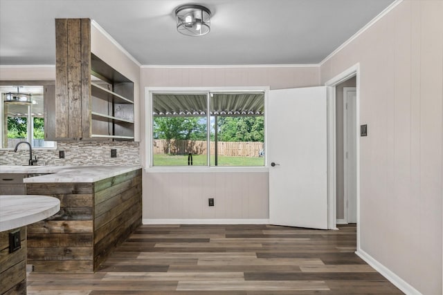 407 Sunset St, Malakoff, TX 75148 - kitchen with light countertops, dark wood-style flooring, crown molding, baseboards, and a sink