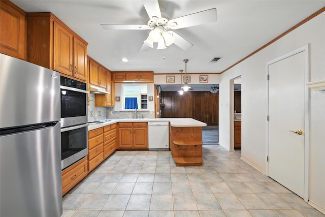 3908 Windhaven Rd, Fort Worth, TX 76133 - kitchen featuring stainless steel appliances, light countertops, under cabinet range hood, tasteful backsplash, and ceiling fan