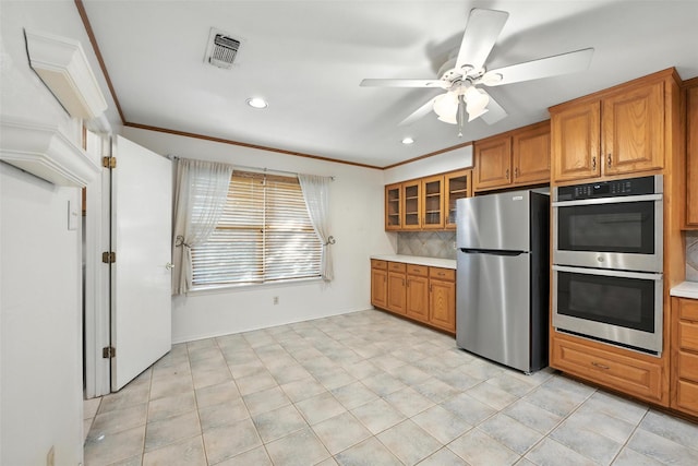 3908 Windhaven Rd, Fort Worth, TX 76133 - kitchen featuring appliances with stainless steel finishes, brown cabinetry, ceiling fan, backsplash, and recessed lighting