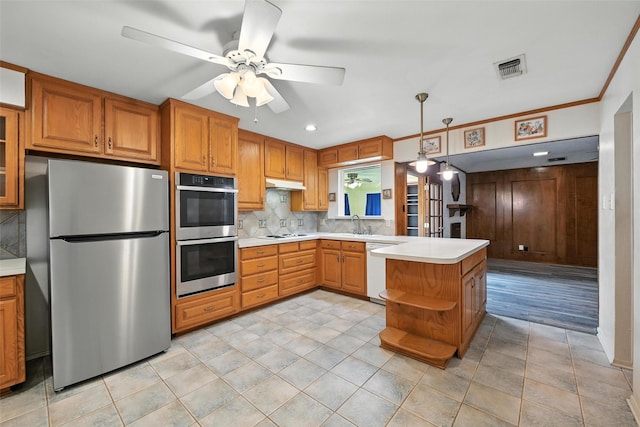 3908 Windhaven Rd, Fort Worth, TX 76133 - kitchen with stainless steel appliances, light countertops, tasteful backsplash, ceiling fan, and a peninsula