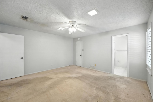 3908 Windhaven Rd, Fort Worth, TX 76133 - unfurnished bedroom featuring carpet flooring, a textured ceiling, ensuite bath, and ceiling fan