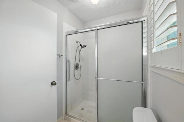 3908 Windhaven Rd, Fort Worth, TX 76133 - bathroom featuring a shower stall and a textured ceiling