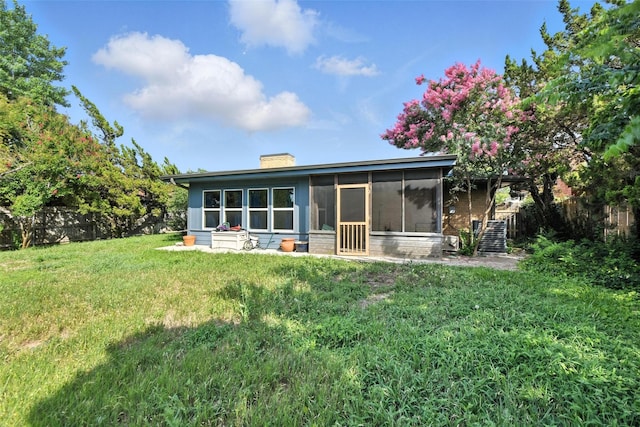 3908 Windhaven Rd, Fort Worth, TX 76133 - rear view of house featuring a chimney and a sunroom
