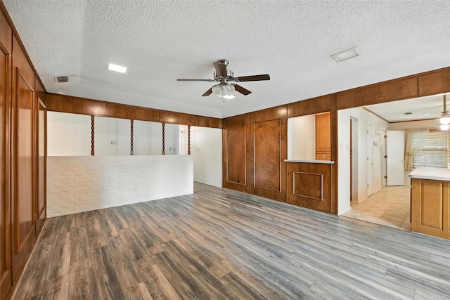 3908 Windhaven Rd, Fort Worth, TX 76133 - unfurnished living room with a ceiling fan, light wood-style floors, and a textured ceiling